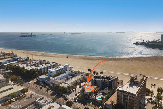 Panoramic view of beachfront buildings and ocean.