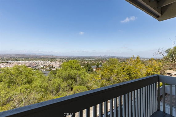 Panoramic view of cityscape and greenery from a balcony.