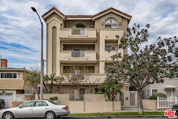 Front view of a multi-story residential building with balconies.