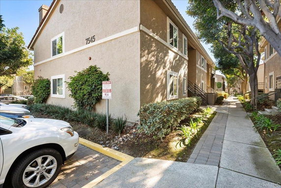 Front view of a two-story residential building with a walkway.
