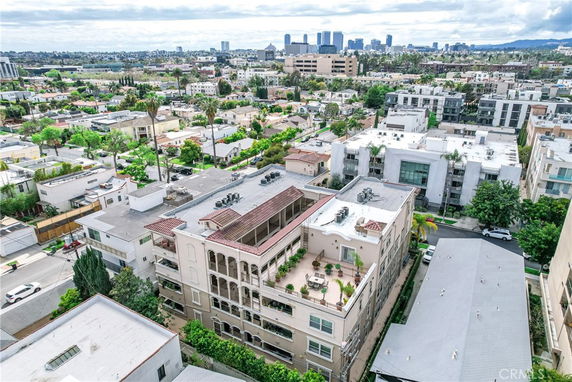 Aerial view of a building rooftop with several units and ventilation systems.