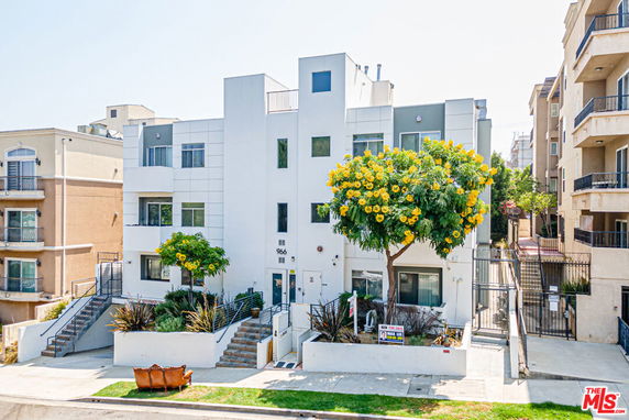 Front view of a multi-story modern apartment building with balconies.