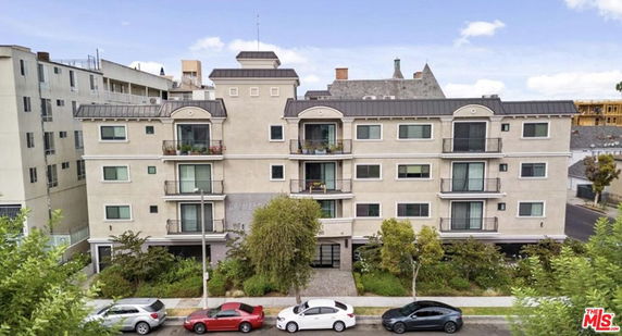 Front view of a multi-story residential building with balconies.