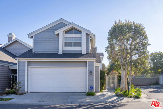 Front view of a two-story house with a garage.