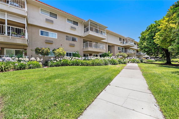 Front view of a multi-story residential building with balconies.