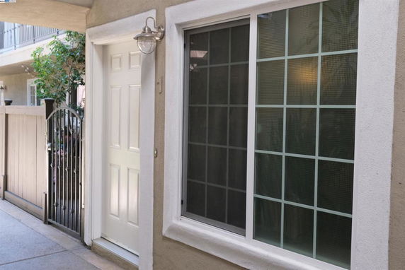 Front view of a residential building entrance with a door and a window.