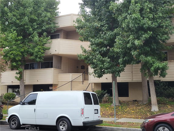 Front view of a multi-story residential building with balconies.
