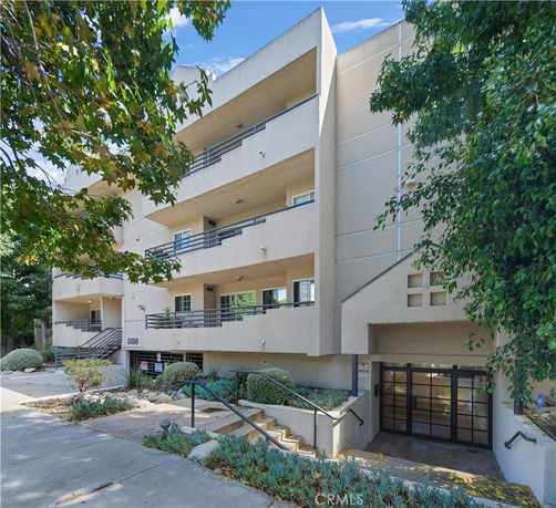 Front view of a multi-story building with balconies.