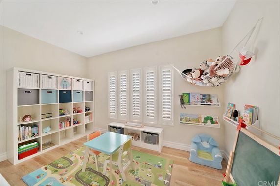 Indoor play area with shelves, toys, and a small table with chairs.
