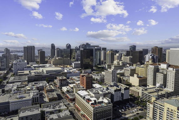 Aerial view of a cityscape with numerous skyscrapers and buildings.