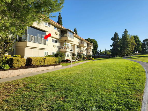 Front view of a multi-story residential building with balconies.
