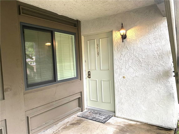 Front view of an entrance with a door and window.