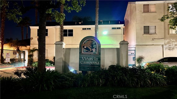 Front view of a multi-story residential building at night.