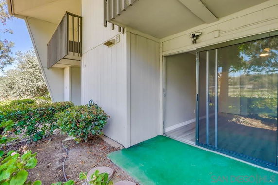 Exterior view of a building with sliding glass doors and a small balcony.