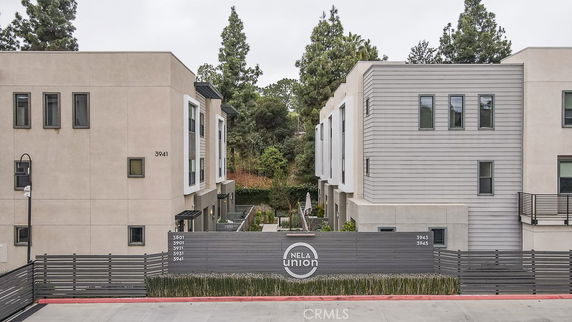 Front view of a modern apartment complex with multiple units and a secured entrance.