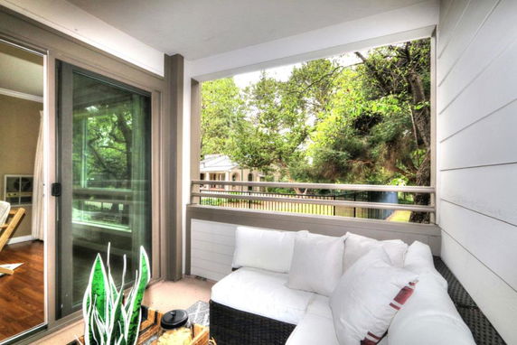 View of surrounding areas seen from the building including trees and a neighboring structure.