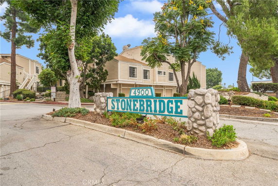 Front view of a residential building complex with multiple units and a sign reading 'Stonebridge'.