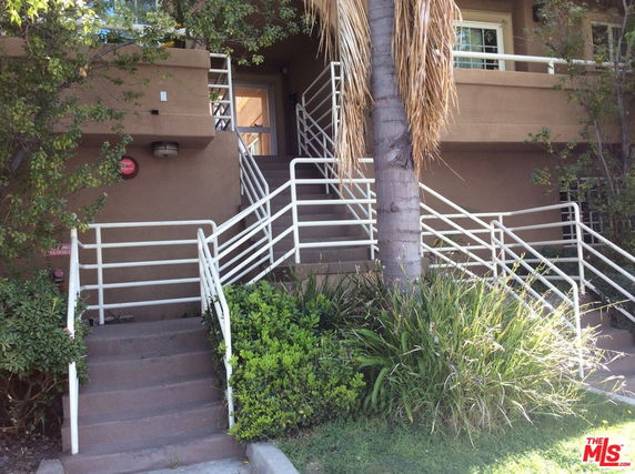 Front view of a building with multiple staircases leading to the entrance.