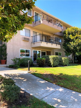 Front view of a multi-story residential building with balconies.