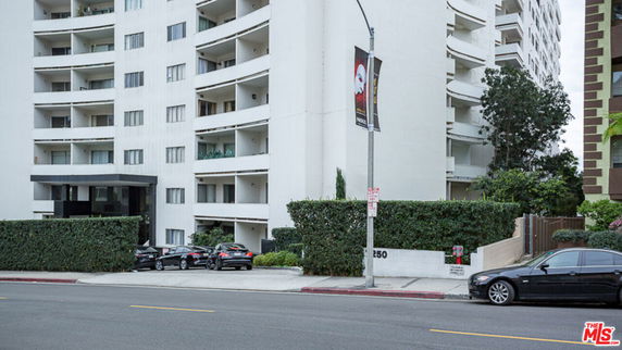 Front view of a multi-story apartment building with balconies
