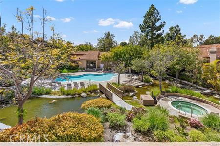View of an outdoor area featuring a swimming pool and landscaped surroundings.
