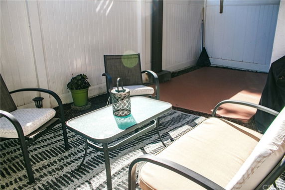 Outdoor patio area with chairs and a table.