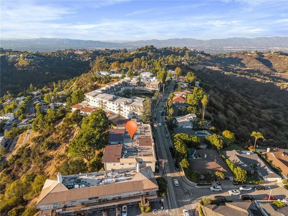 Panoramic view of a hilly residential area with buildings and roads.