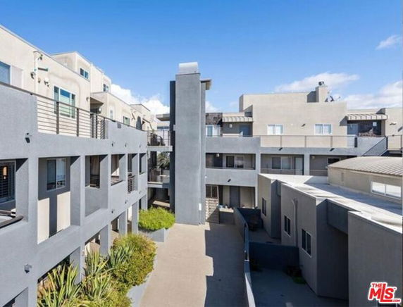 Front view of a multi-story apartment complex with modern design features.