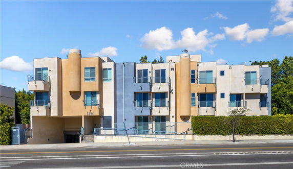 Front view of a modern multi-story building with geometric design elements.