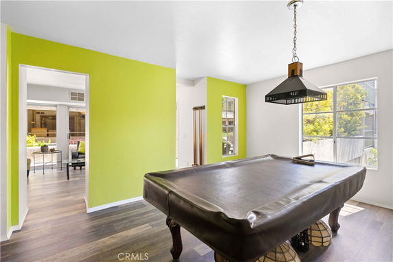 Room with a pool table and bright walls.
