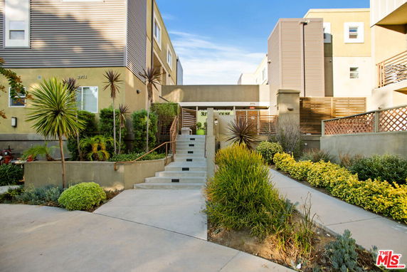 Front view of a multi-story residential building with modern design.