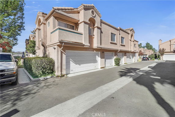 Front view of a two-story townhouse with attached garages.