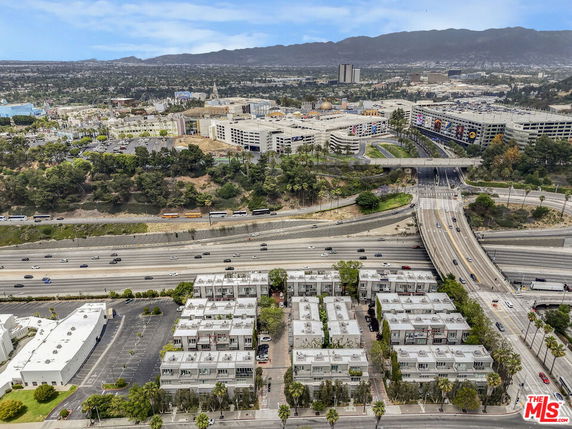 Panoramic view of a cityscape with multi-story buildings and highways.