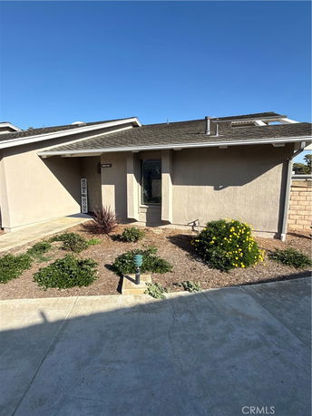 Front view of a single-story house with a sloped roof.