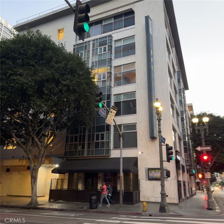 Front view of a multi-story building with large windows on a street corner.