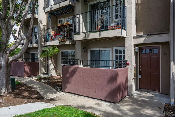 Front view of a multi-story apartment building with balconies.