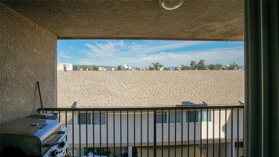 Rooftop view from a balcony with satellite dishes visible.