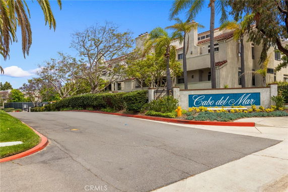 Front view of a residential complex with landscaping and signage reading 'Cabo del Mar'.