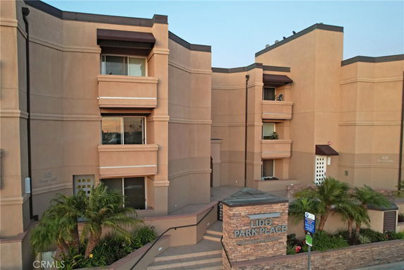 Front view of a multi-story building with balconies and a main entrance.