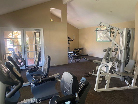 Indoor gym area with exercise equipment in a clubhouse setting.