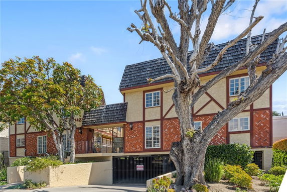 Front view of a two-story house with Tudor architectural style.