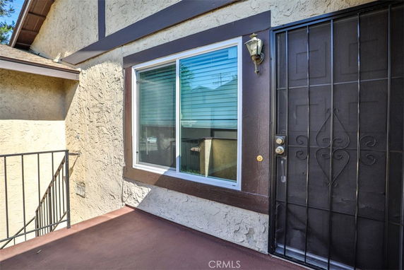 Front view of a house with a metal security door and window.