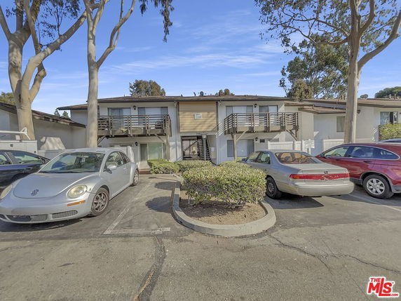Front view of a two-story residential building with multiple balconies.
