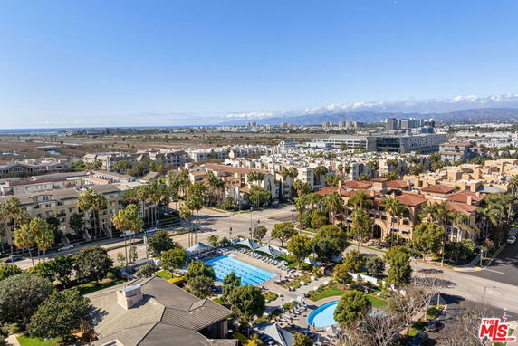 Panoramic view of a residential area with a swimming pool and surrounding buildings.