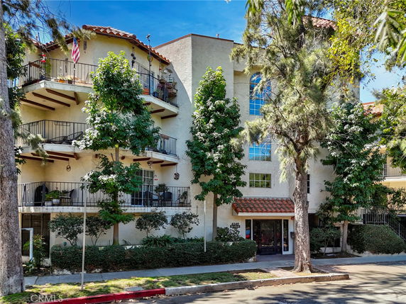 Front view of a multi-story residential building with balconies.