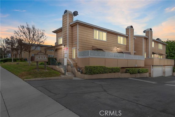 Front view of a modern multi-story building with chimneys and a sign reading La Habra Plaza.