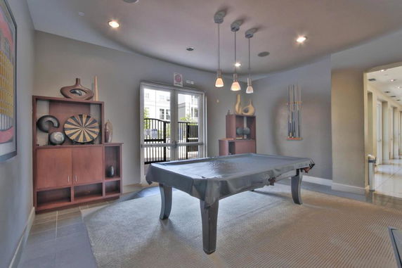 Room with a billiards table and decorative shelves