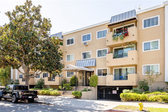 Front view of a multi-story residential building with balconies.
