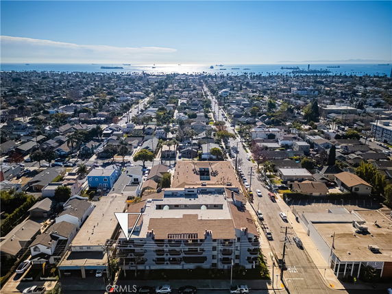 Aerial view of a residential area with distant view of the ocean and ships.