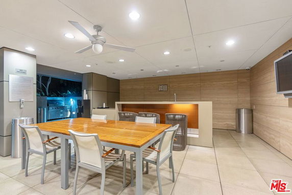 Indoor recreation area with a table, chairs, and bar counter.